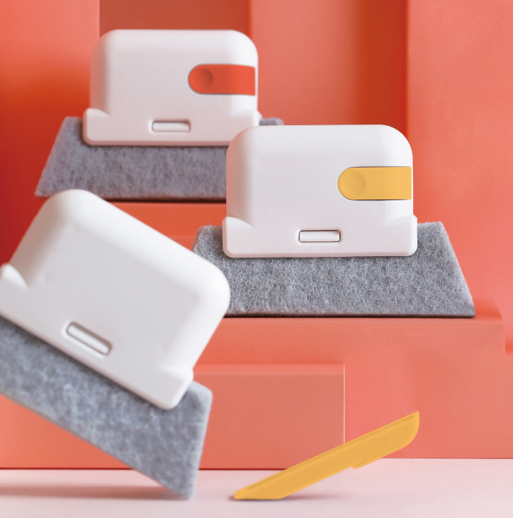 Three cleaning brushes with grey pads in white, orange and yellow accents, arranged on steps