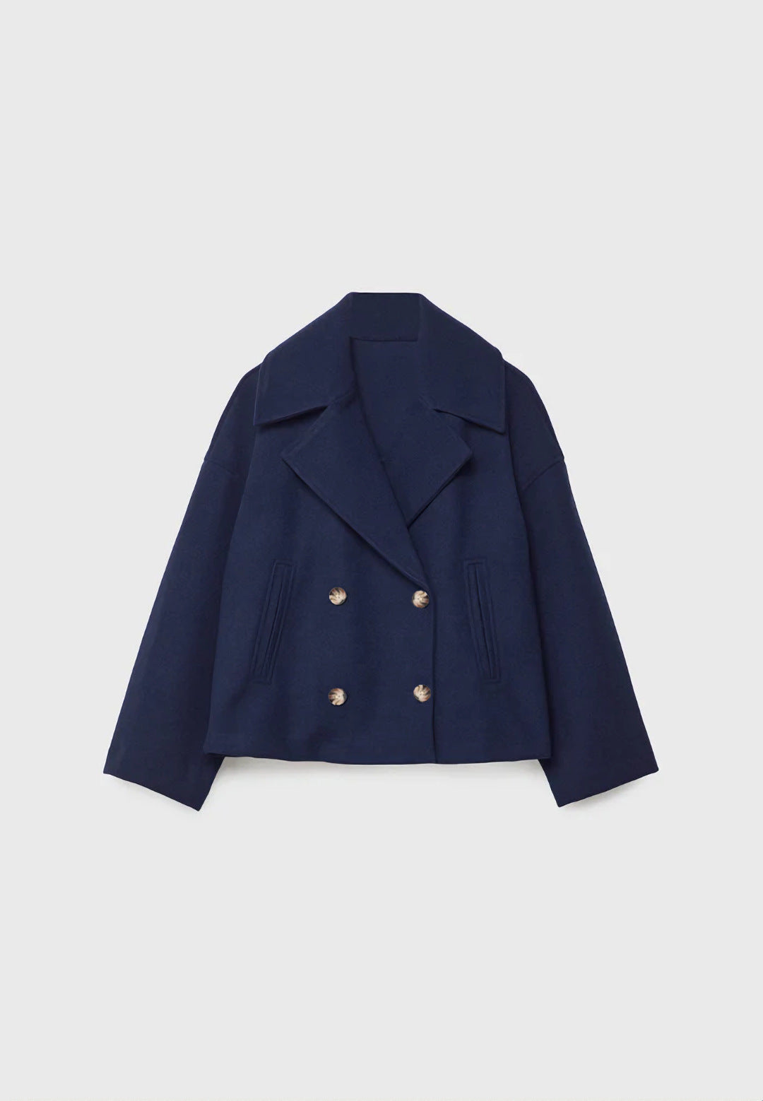 Cropped double-breasted jacket in navy blue, flat lay, front view, on a light background