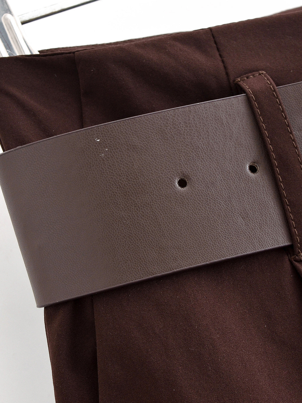 Close-up of the wide brown belt and belt loops at the back of chocolate brown trousers
