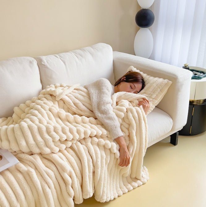 Milky White ribbed throw over a person resting on a white sofa