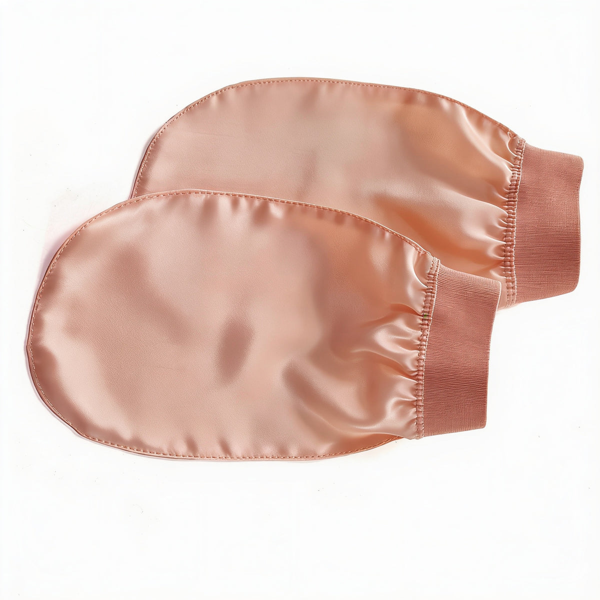 Two deeper peach viscose wash gloves with darker peach cuffs, laid flat on a white surface