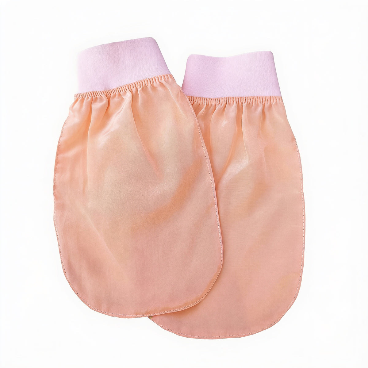 Two peach viscose face and body gloves with pink elastic cuffs, laid flat on a white background