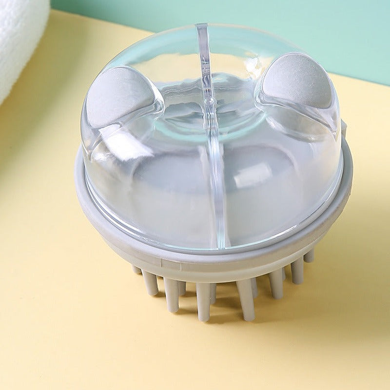 Grey shampoo brush with clear dome and two top buttons, top view on a yellow and mint background