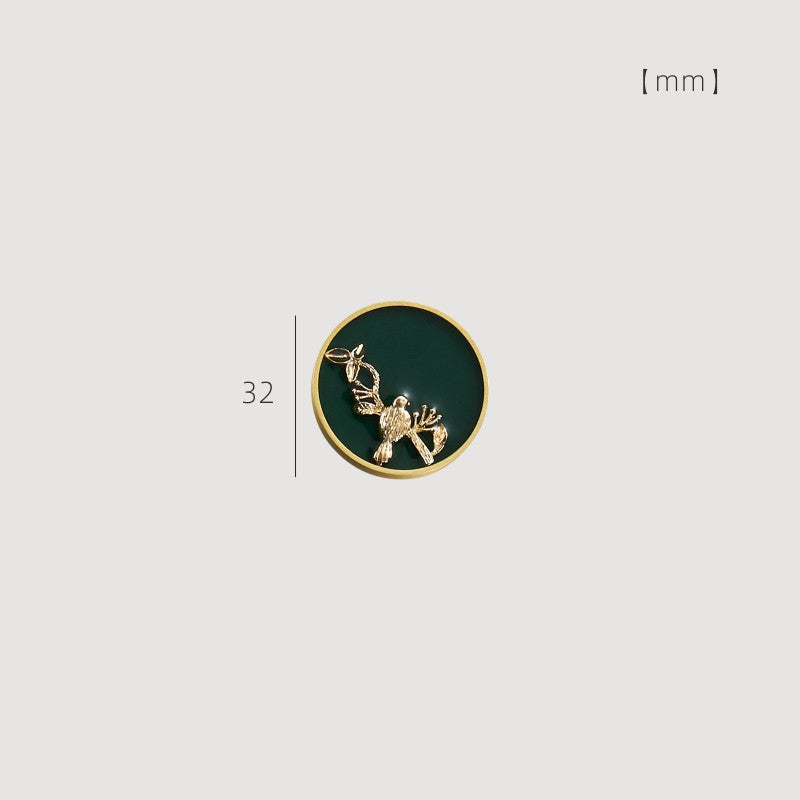 32 mm enamelled drawer knob with gold-tone rim and green background featuring a morning bird design