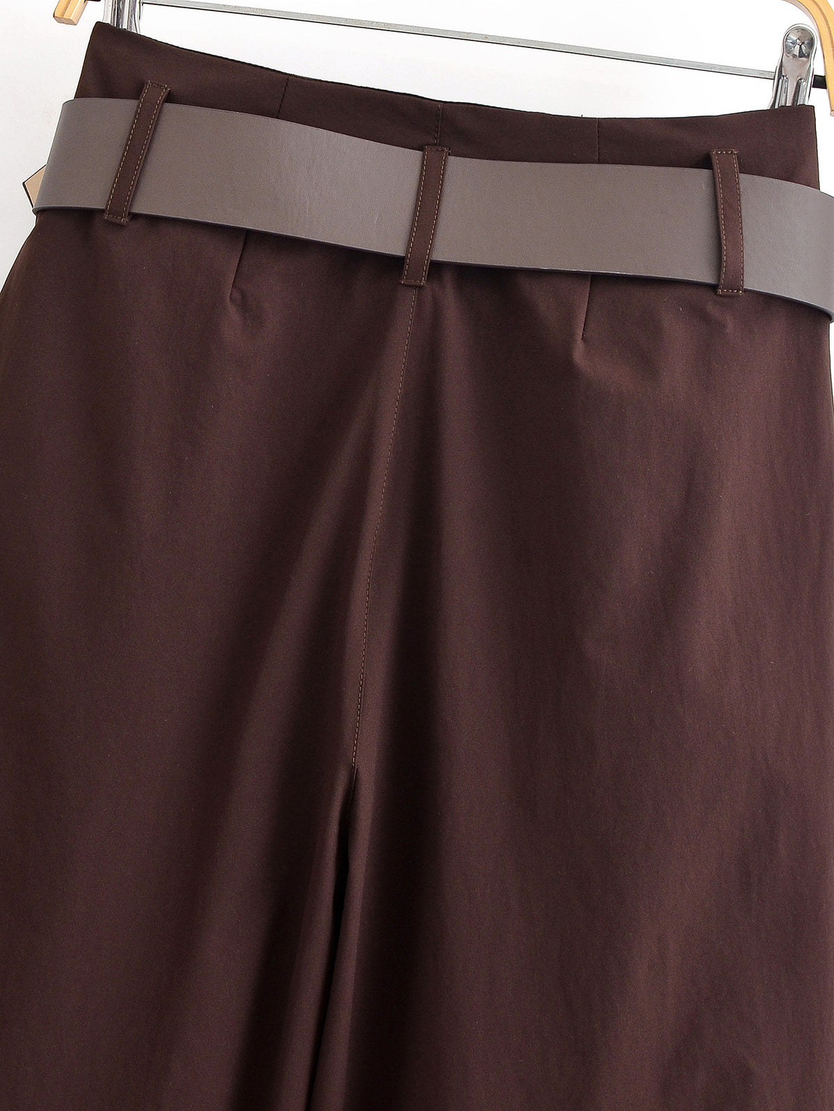 Back view of chocolate brown wide-leg trousers on a hanger, showing the belt loops and belt