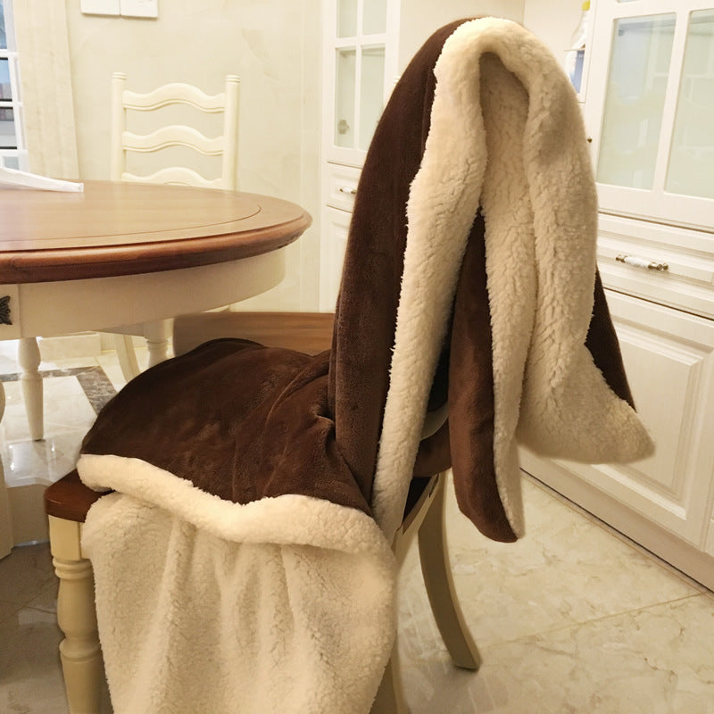 Reversible flannel throw in brown with cream sherpa lining, draped over dining chair in kitchen setting