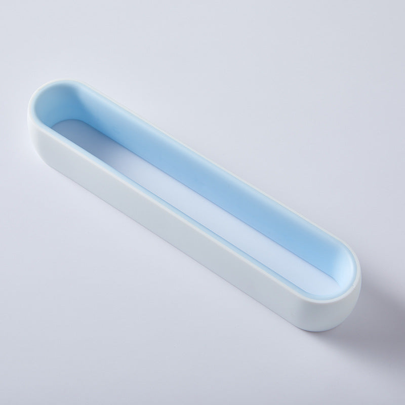 Blue and white wall-mount slipper rack, empty, flat lay, top view, on light surface