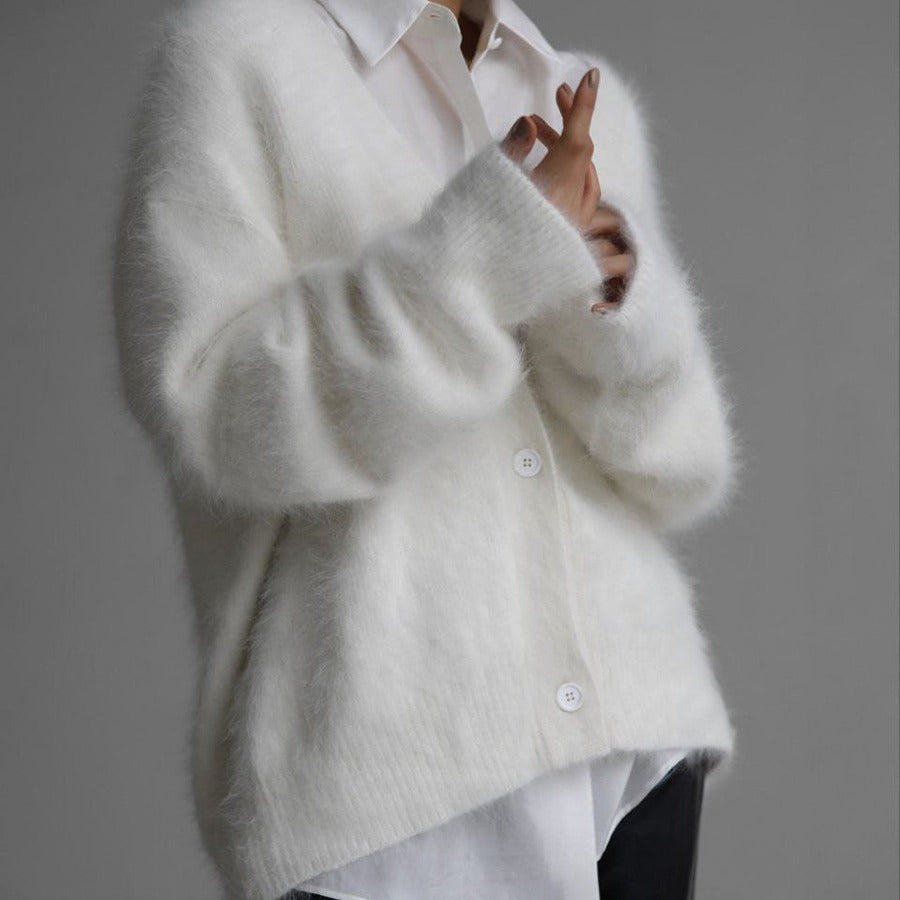 Fluffy oversized V-neck cardigan in white, front view on model, button front, layered over a white shirt