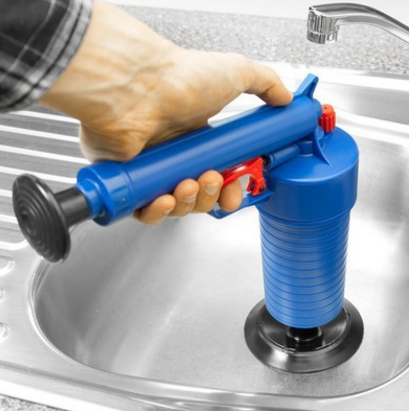 Blue pump-action drain tool with red trigger used in a stainless steel sink