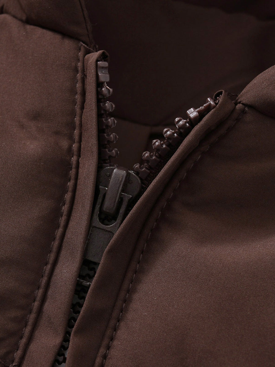 Close-up of the centre zip on the coffee brown puffer jacket, showing the zip pull and stitched placket