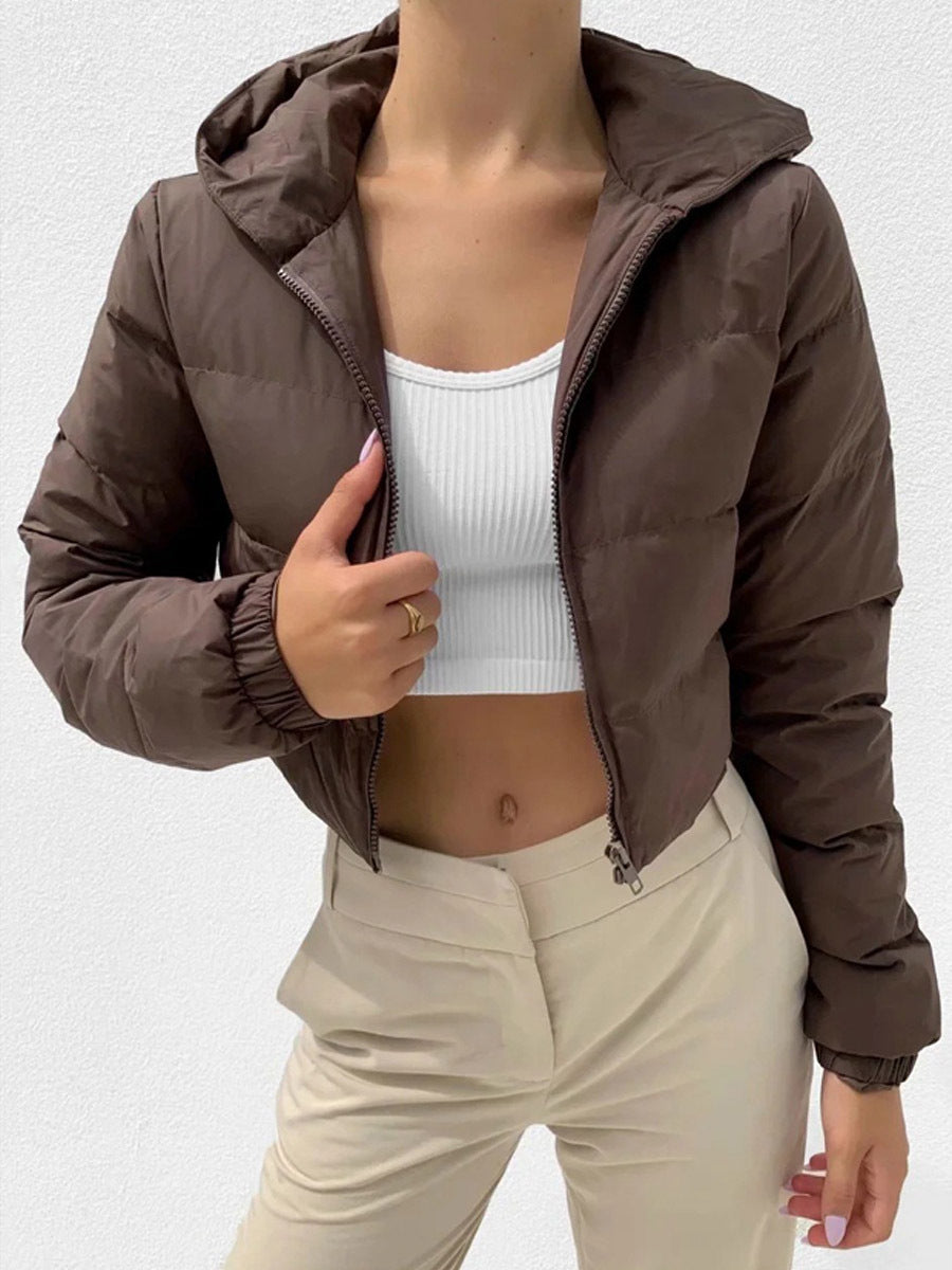 Coffee brown cropped hooded puffer jacket, worn by a model, front view with hand on the zip