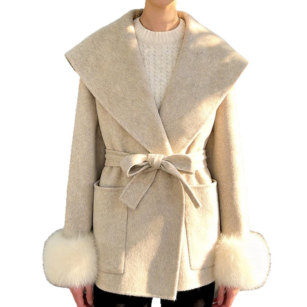 Beige short wrap coat with wide collar and fluffy cuffs worn by model, front view