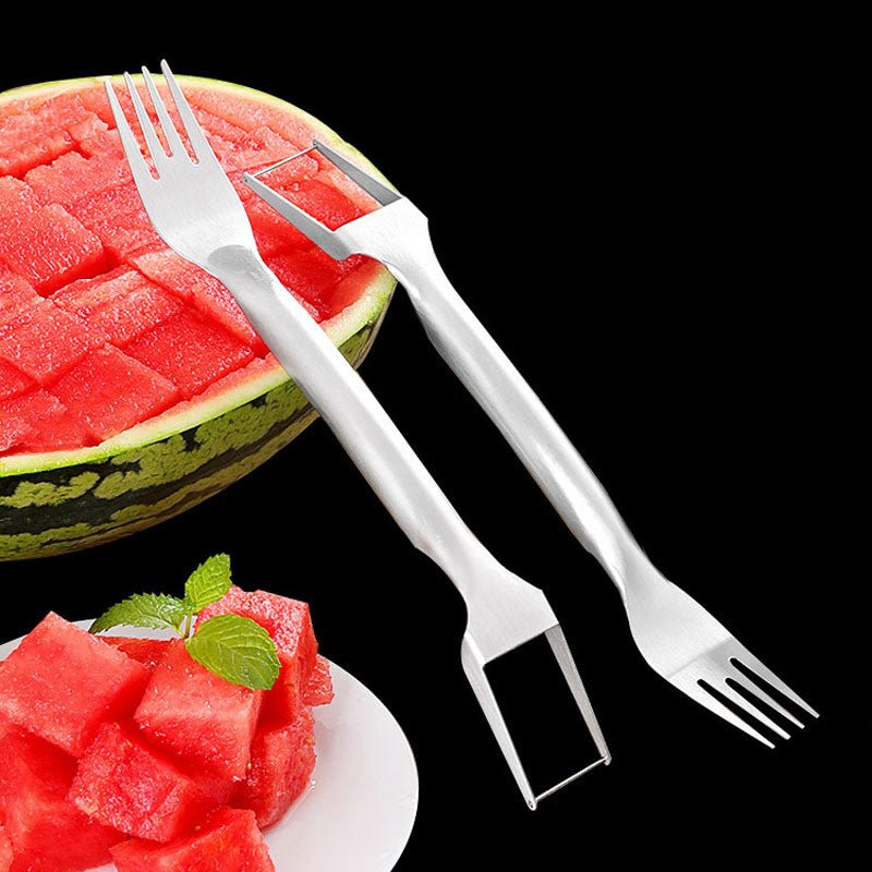 2-in-1 stainless steel watermelon fork and cutter, silver, shown with sliced watermelon and cubes on a plate, front view