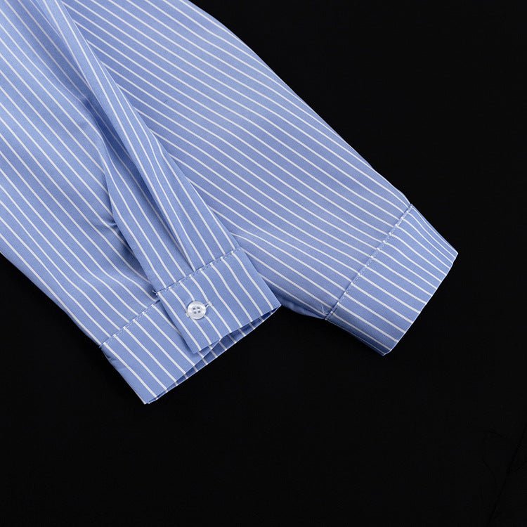 Close-up of the blue and white striped shirt sleeve with buttoned cuff