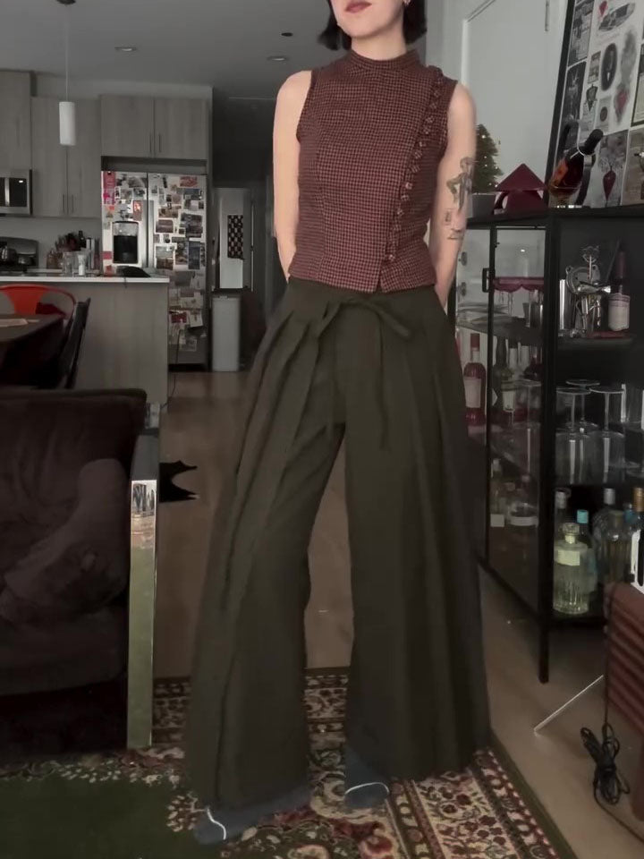 Olive wide-leg trousers with tie waist, full front view on model standing in home interior