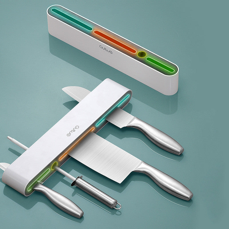 Wall-mounted magnetic knife bar with hooks, white, flat lay showing internal colored channels and knives inserted