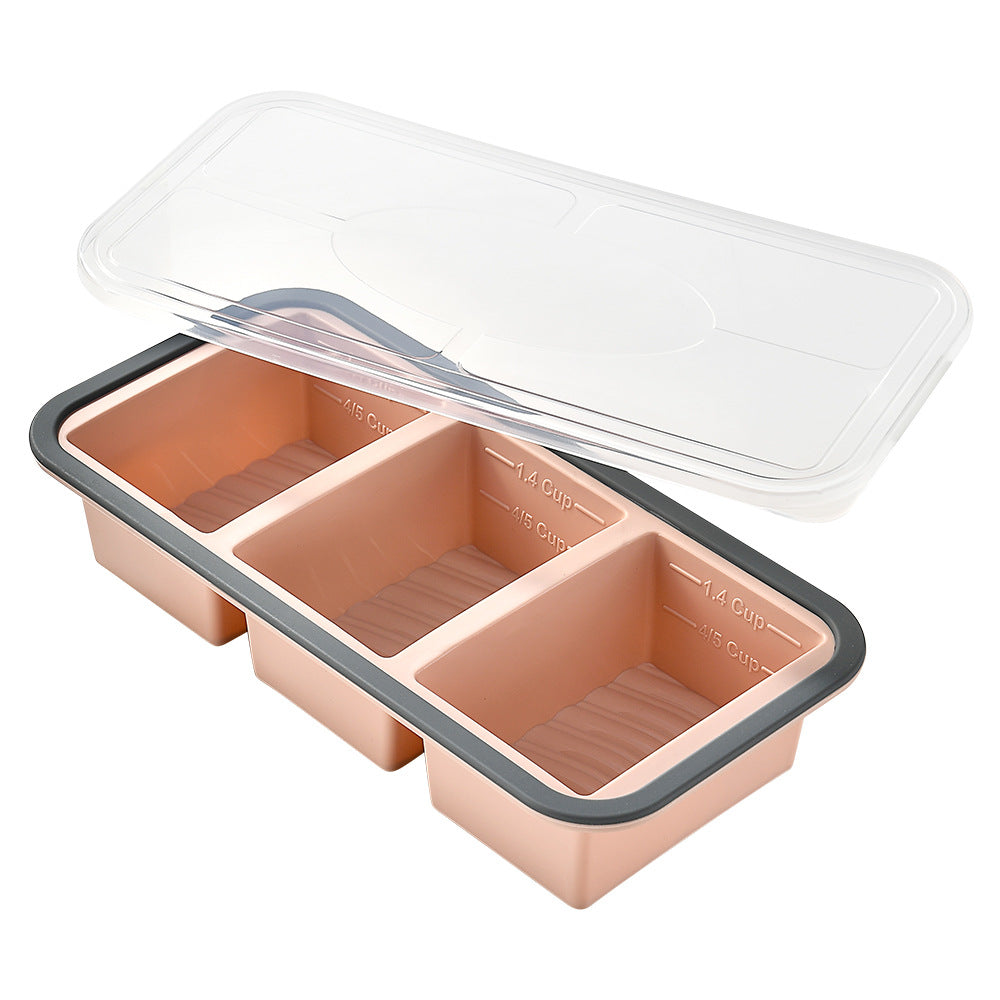 Three-compartment silicone freezer portion tray, peach colour, grey rim, clear lid, measuring marks, front view