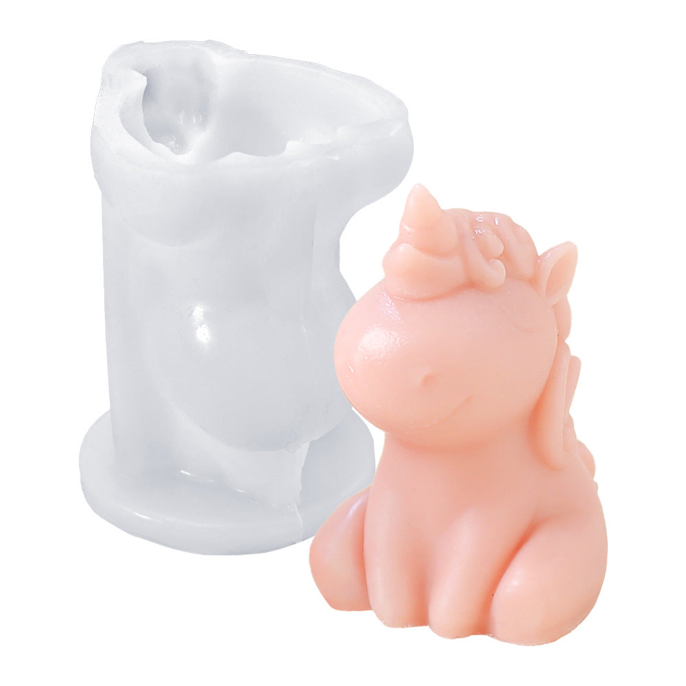 White silicone mould and pink unicorn-shaped candle side by side, showing mould shape and finished product