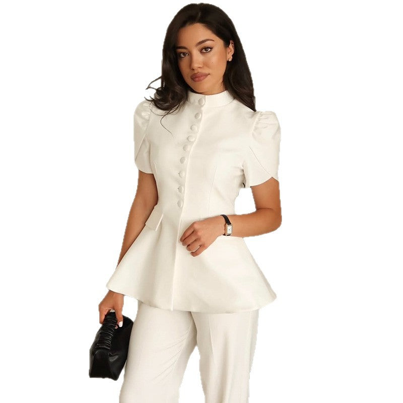 White stand-collar peplum top and trousers set on model, front view against white background, holding black clutch