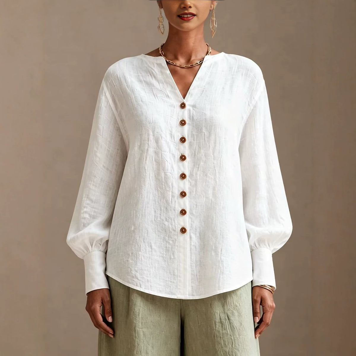 White V-neck lantern-sleeve blouse with wood-tone buttons, front view on model