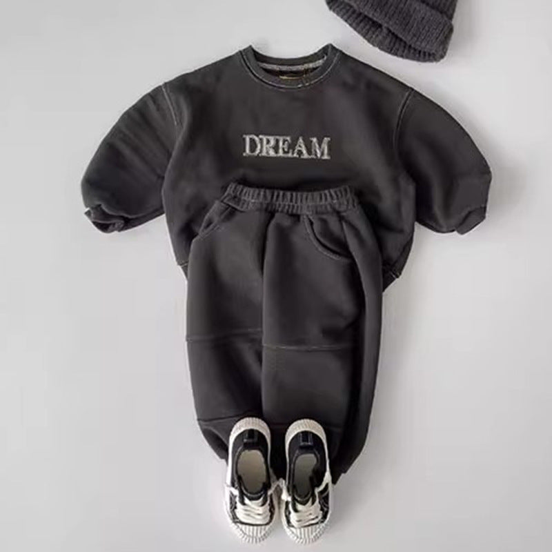 Dark grey set laid out with trainers and a knitted hat