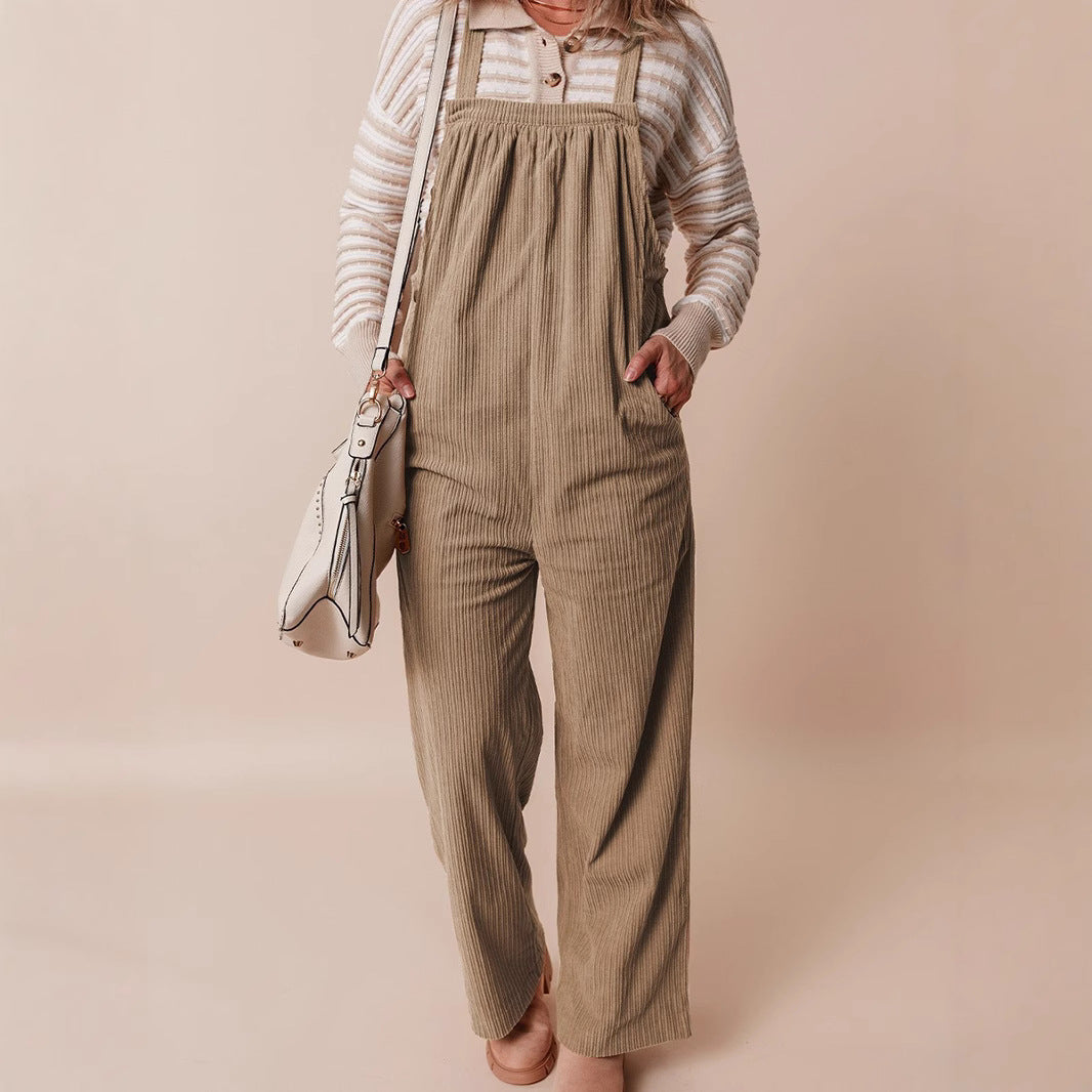Corduroy wide-leg dungarees in beige with vertical stripes, worn front view on model with striped top and white bag