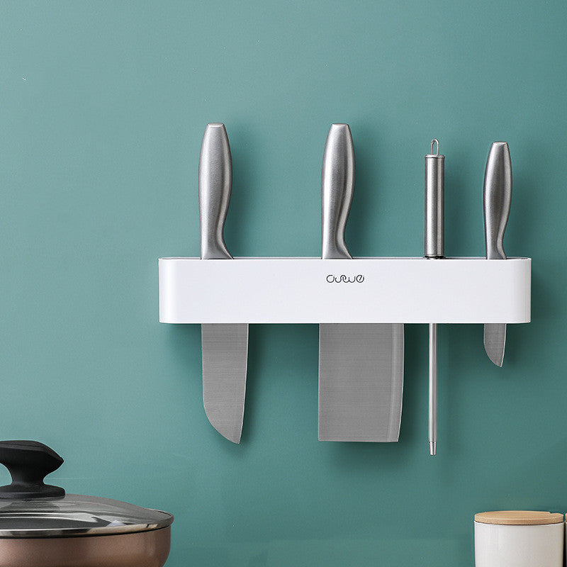 Wall-mounted magnetic knife bar with hooks, white, front view with four knives inserted, mounted on teal wall