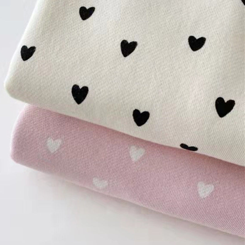 Close view of the cream and pink heart print fabric