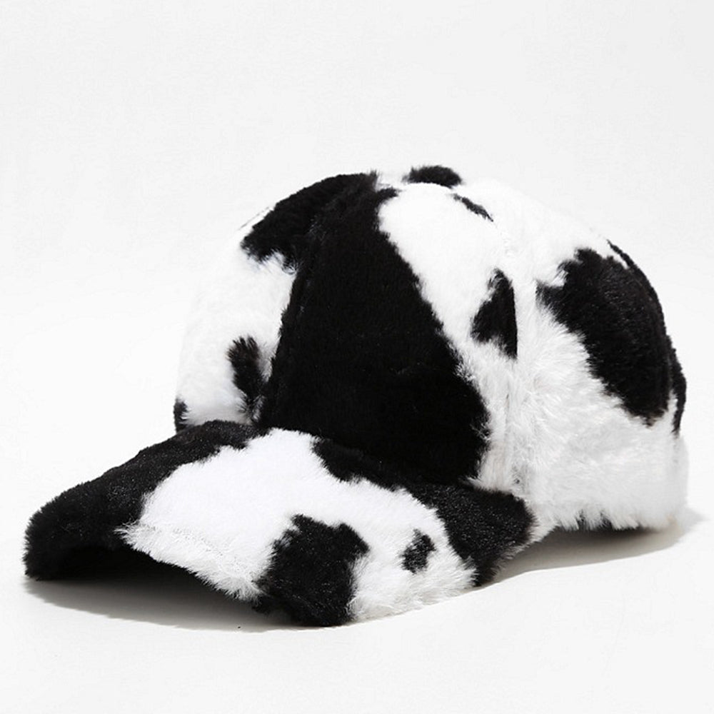 Plush baseball cap in black-and-white cow-spot pattern, front view on white background