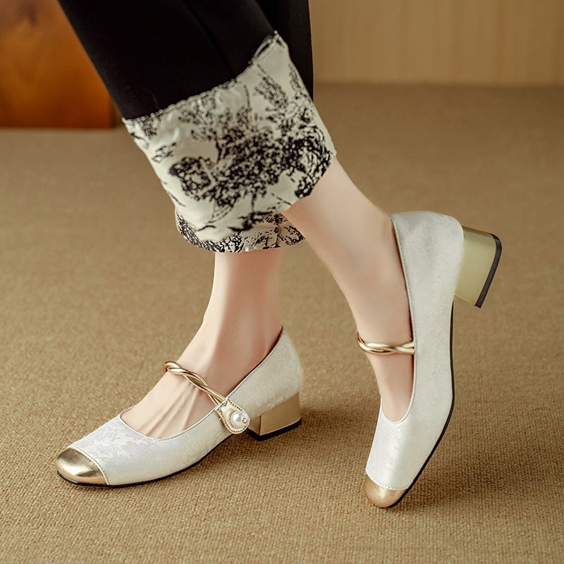 Retro Mary Jane pumps in silver with gold-tone toe cap and pearl-look strap, worn on feet, standing view
