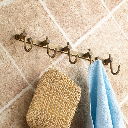 The hook rail seen from the side, holding a sponge and a blue towel