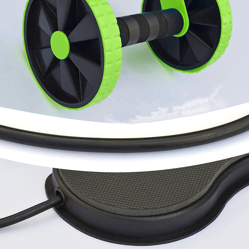 Close-up of ab roller wheel with green wheels and black handle, connected to black rope, resting on cushioned base