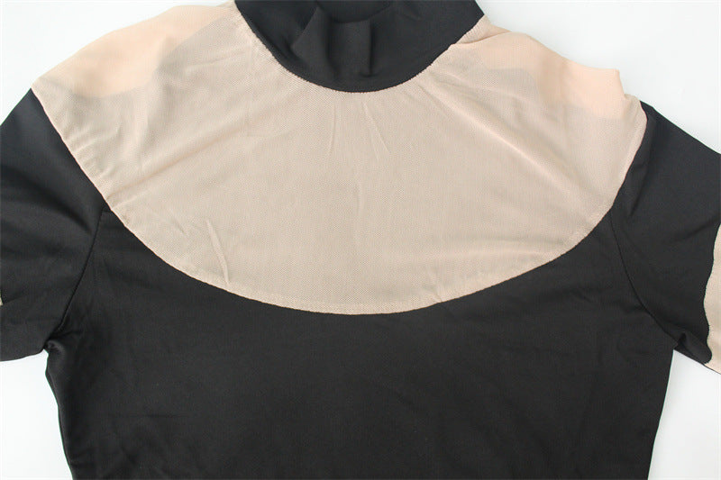 Flat lay close-up of the bodysuit upper part, showing nude mesh yoke and curved seam to black fabric