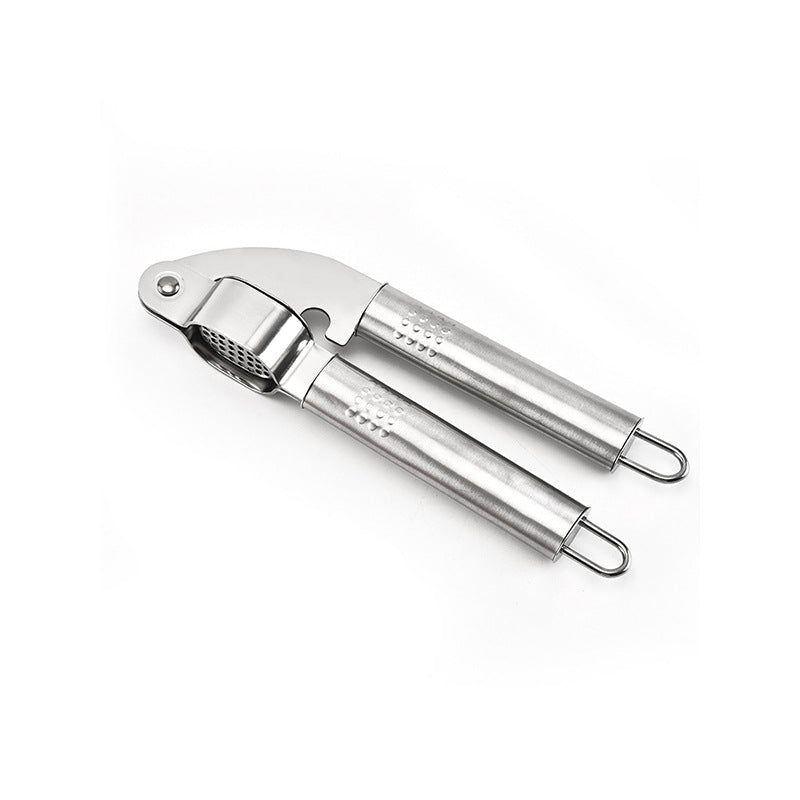 Flat lay of stainless steel garlic press with perforated plate and hanging loops on white background