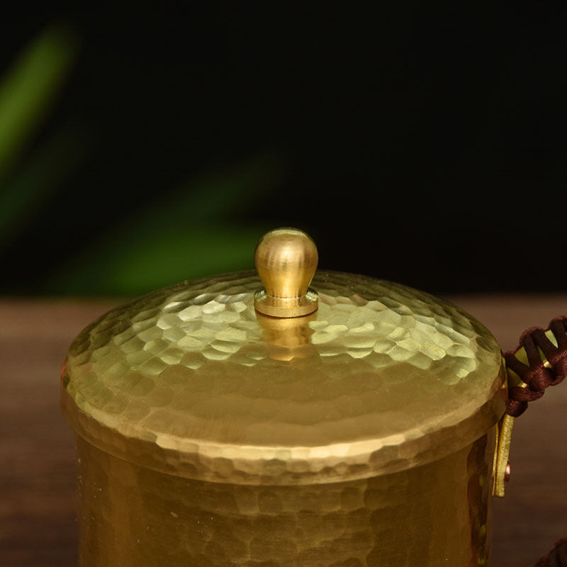 Close-up of hammered brass mug lid with knob, top view