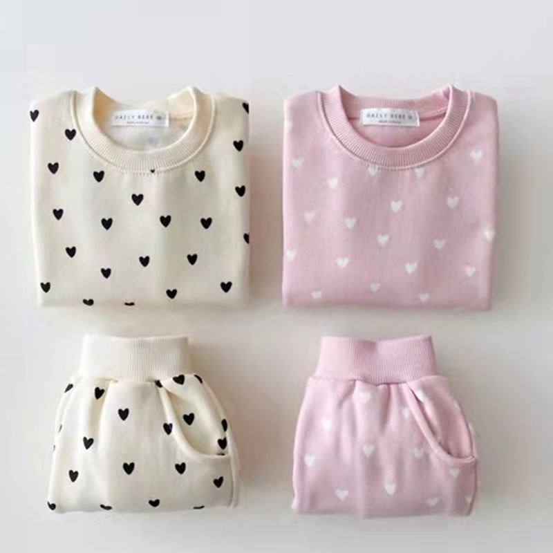 Both sets side by side, trousers with ribbed waistband and pockets
