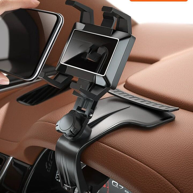 Adjustable clip-mount car phone holder in black, attached to a car dashboard, holding a smartphone, showing front view in use