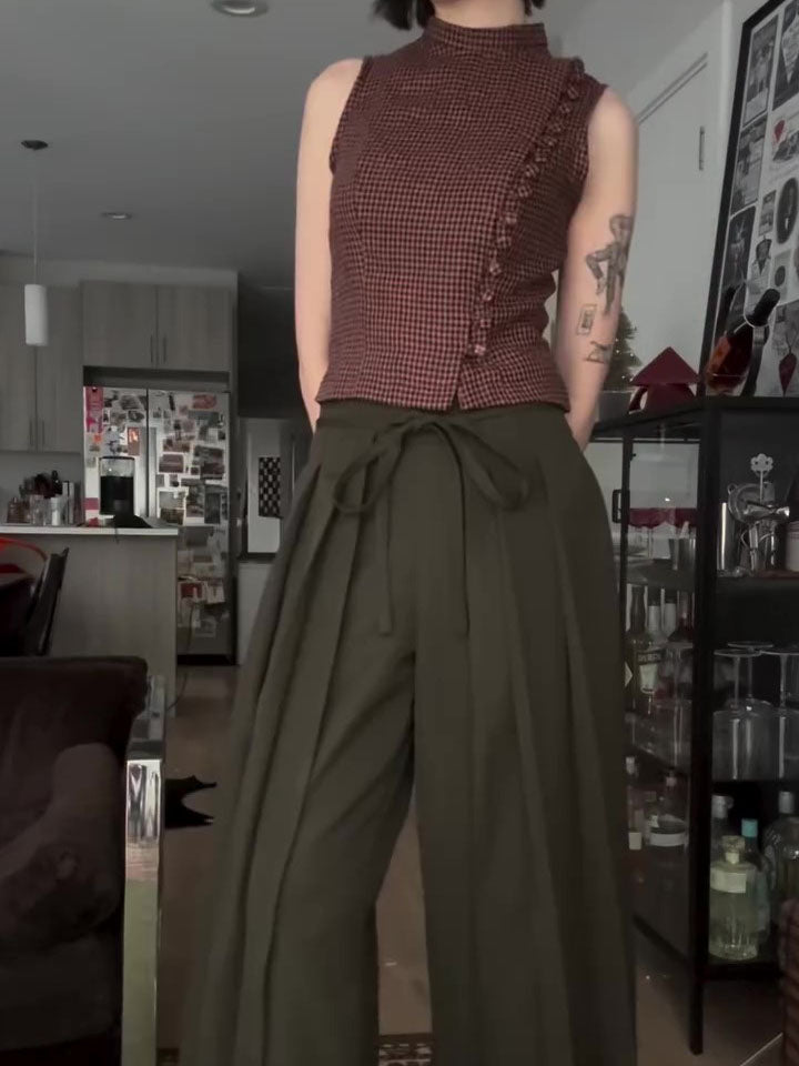Olive wide-leg trousers with tie waist, back view on model in domestic setting