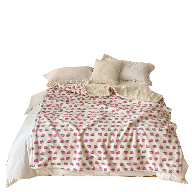 Double-Layer Tufted Flower Blanket with strawberry pattern spread on a bed with pillows, showing full size and design