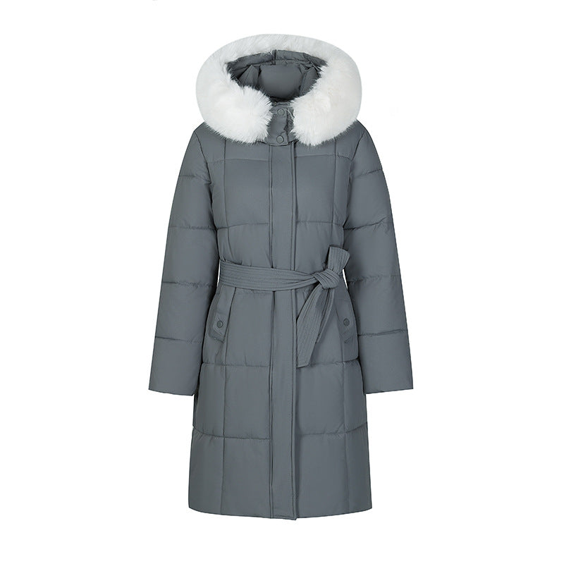 Mid-length padded coat in grey with faux-fur hood and tie belt, front view on white background