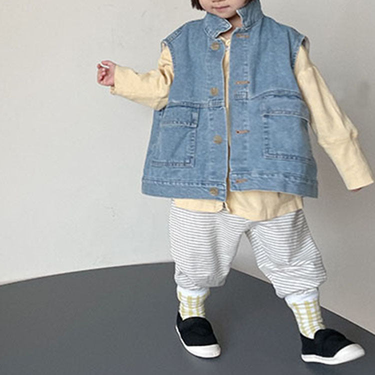 Child wearing the deep blue denim vest over a yellow top