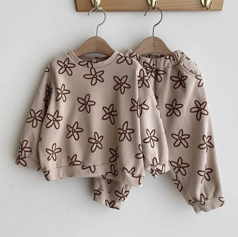 Flower print sweatshirt and trousers on hangers