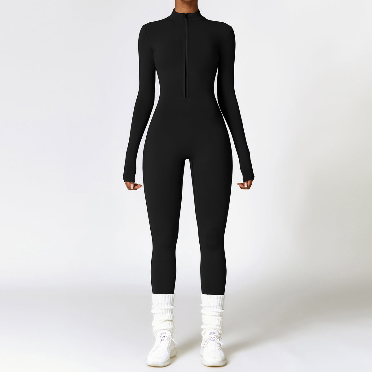 Long-sleeve zip-front brushed jumpsuit in black, full-body front view on model with white socks and sneakers