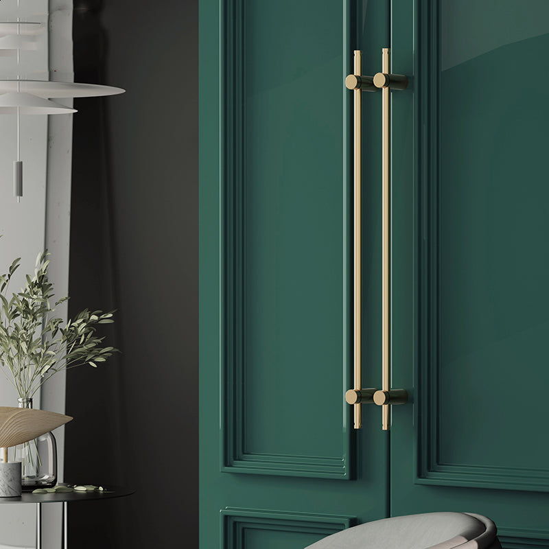 Slim bar cabinet handle in brushed gold-tone mounted on a green door, front view, in use