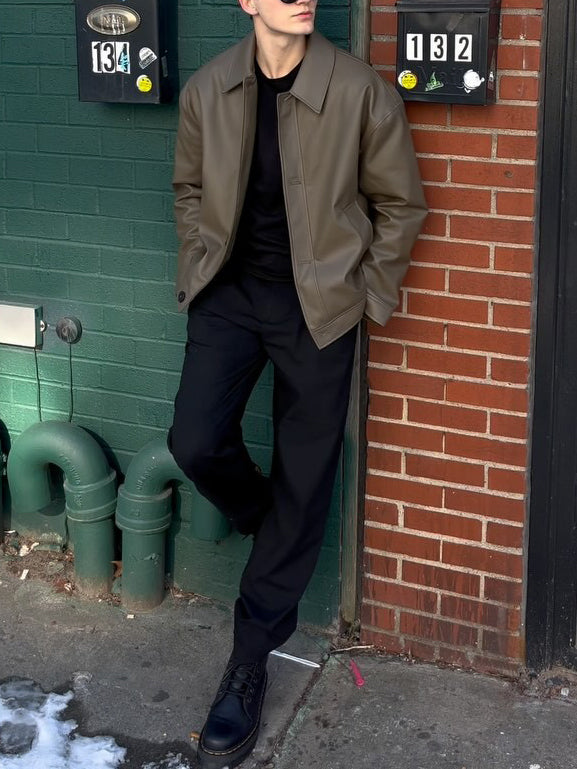 Olive leather-look bomber jacket, full front view on model with hands in pockets