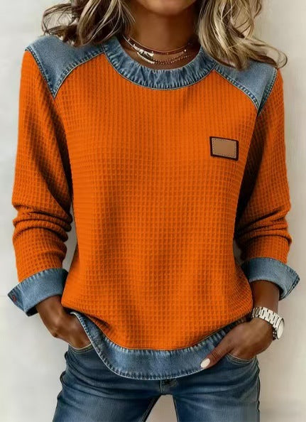 Orange long-sleeve waffle-knit top with denim-look yoke and chest patch, front view on model