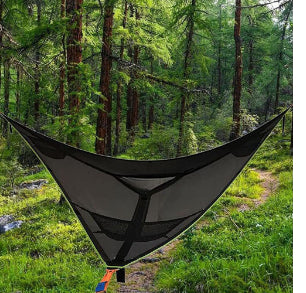 Three-point triangle hammock in black, suspended in a forest, empty, viewed from the side