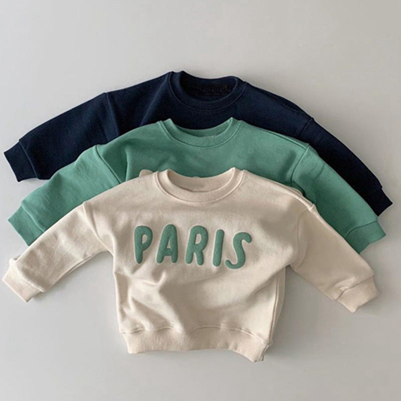 Kindertrui van katoen in marineblauw, groen en wit op elkaar