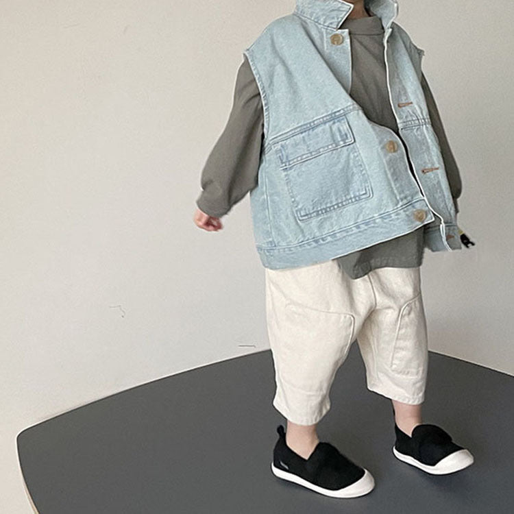 Child wearing the light blue denim vest over a grey top