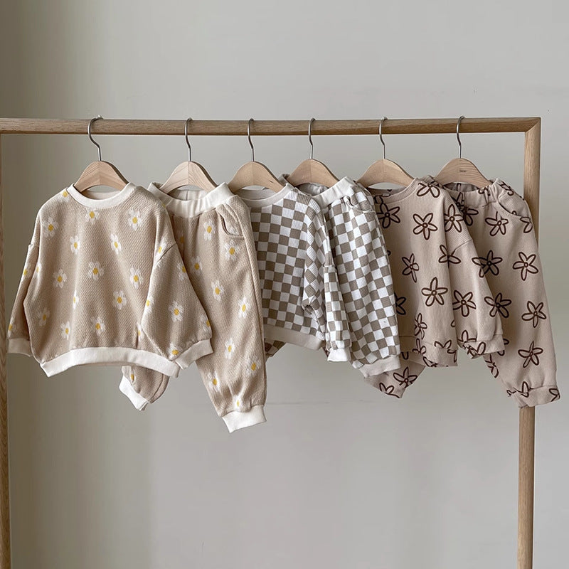Three kids' sweatshirt and trousers sets on a rail